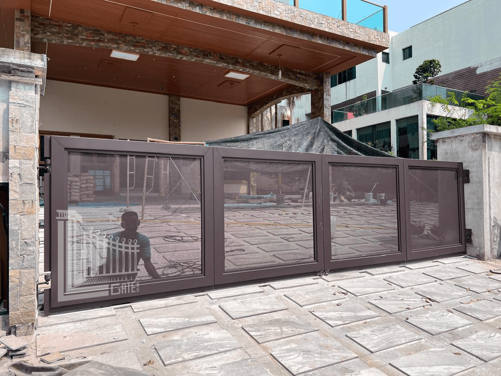 Trackless folding gate installed at a residential driveway in Perak with a clear, flush floor