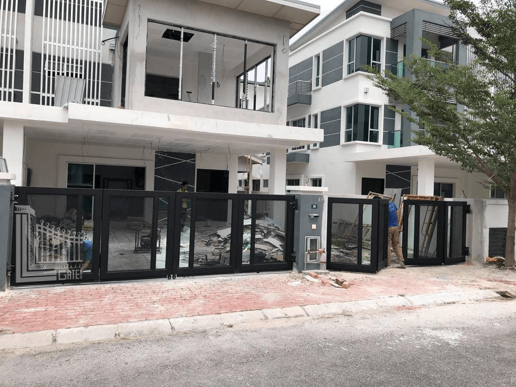 Glass-panel folding gate partly folded open at a home in Perak, Malaysia