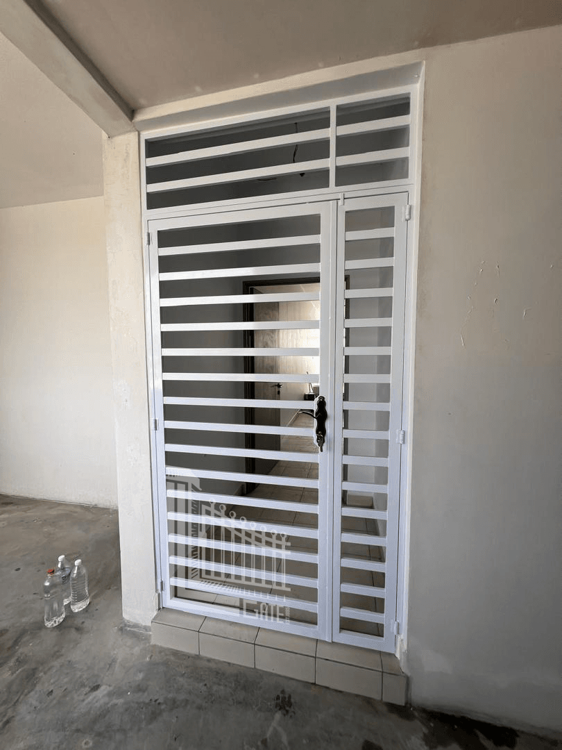 Grill door allowing airflow and light into a home entrance in Ipoh, Perak